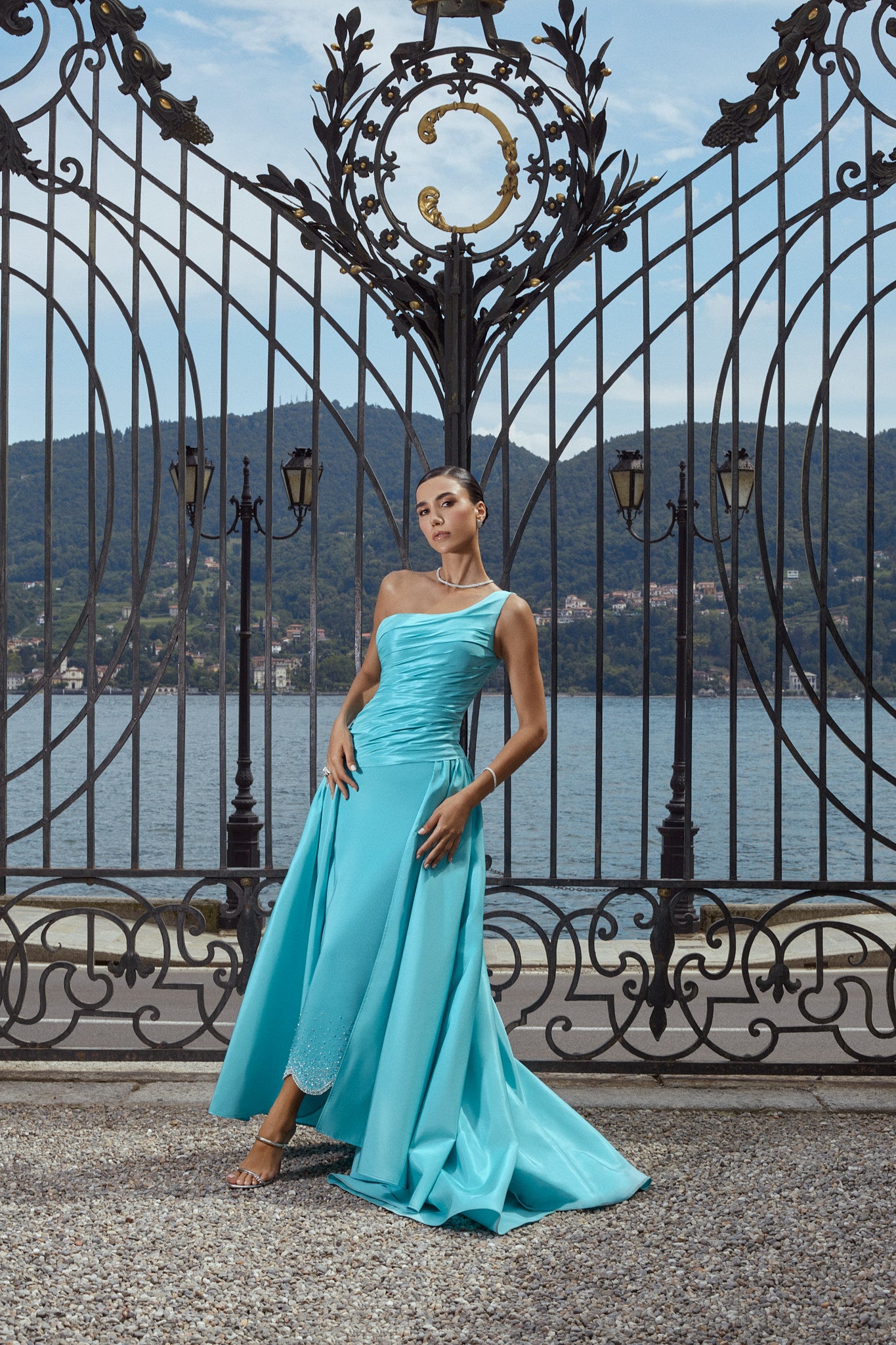 Turquoise satin dress with one shoulder and matching pleats at the chest