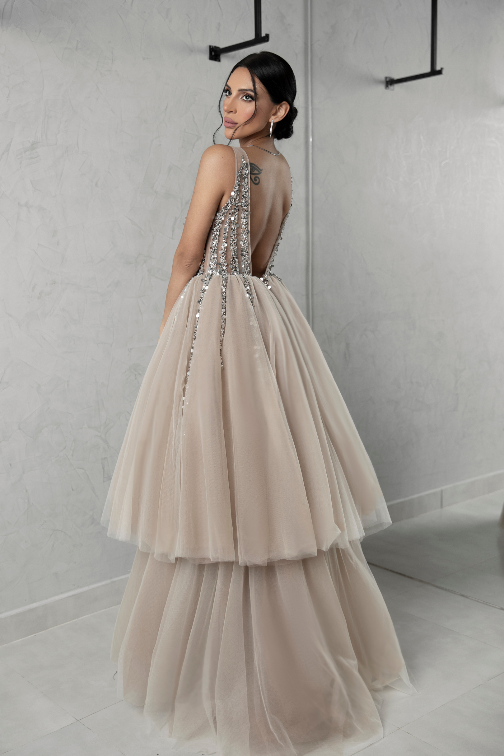Evening dress decorated with shiny stones on the chest and two layers of tulle