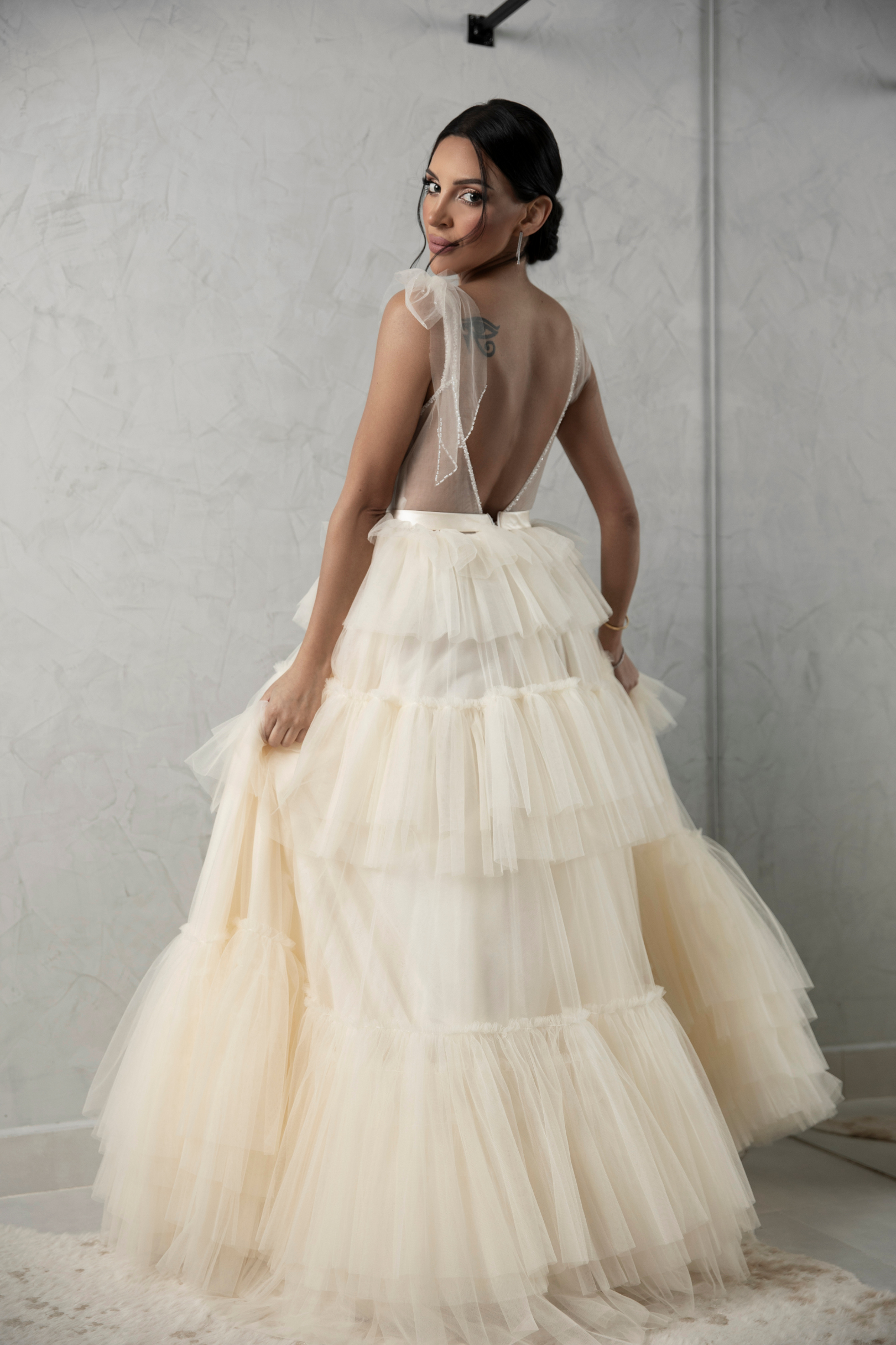 Elegant white evening dress with a creative design made of tulle and shiny satin