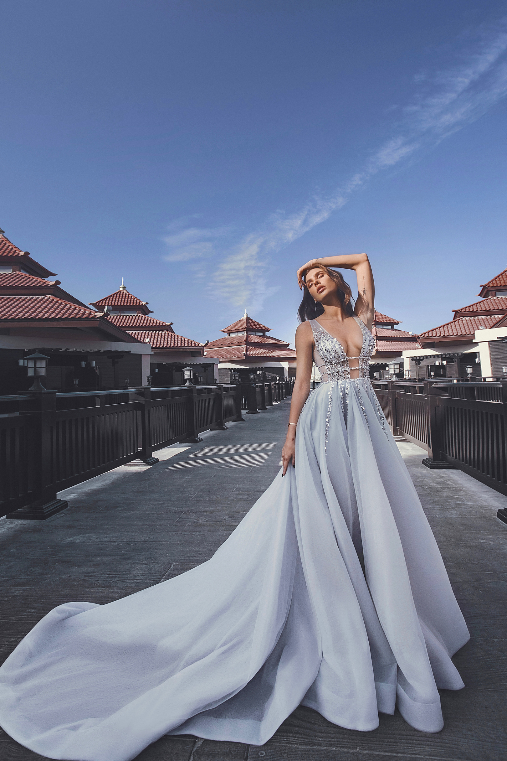 Light blue evening dress with a back decorated with shiny straps
