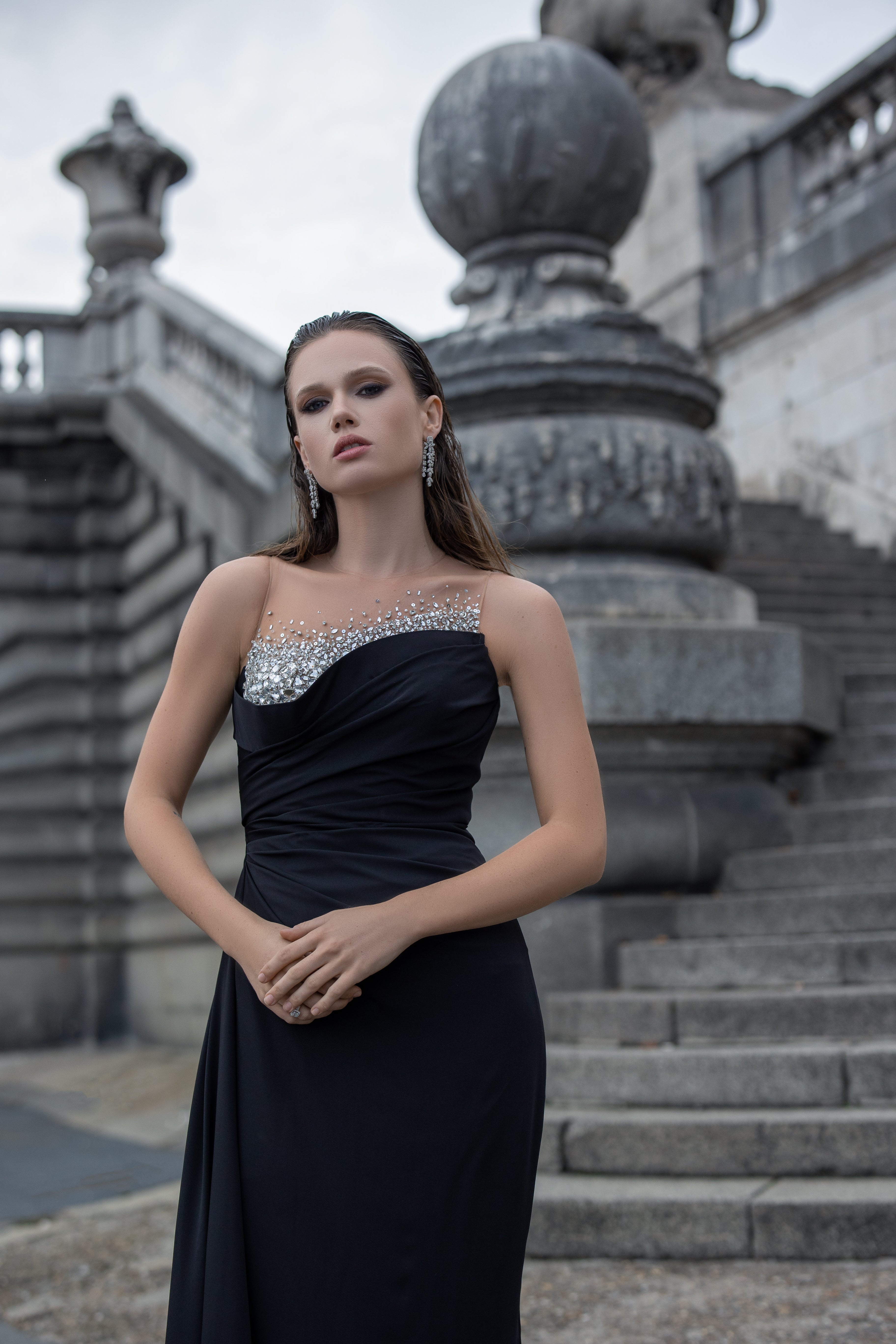 Classic black dress decorated at the chest with a shiny crystal stone
